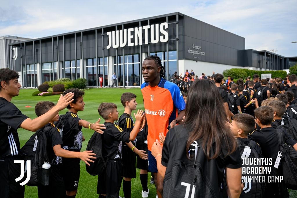Young football camp participants meeting Juventus first team player at Continassa training centre during exclusive meet and greet